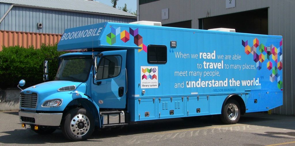 Bookmobile with quotation from Nelson Mandela: "When we read we are able to travel to many places, meet many people, and understand the world."