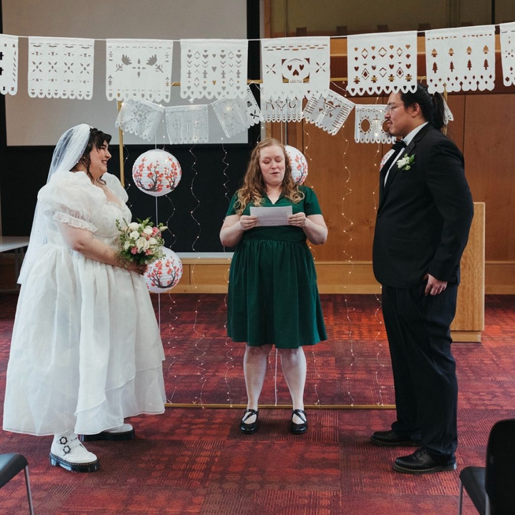 Bride and Groom stand in front of officiant at Ferndale Libary