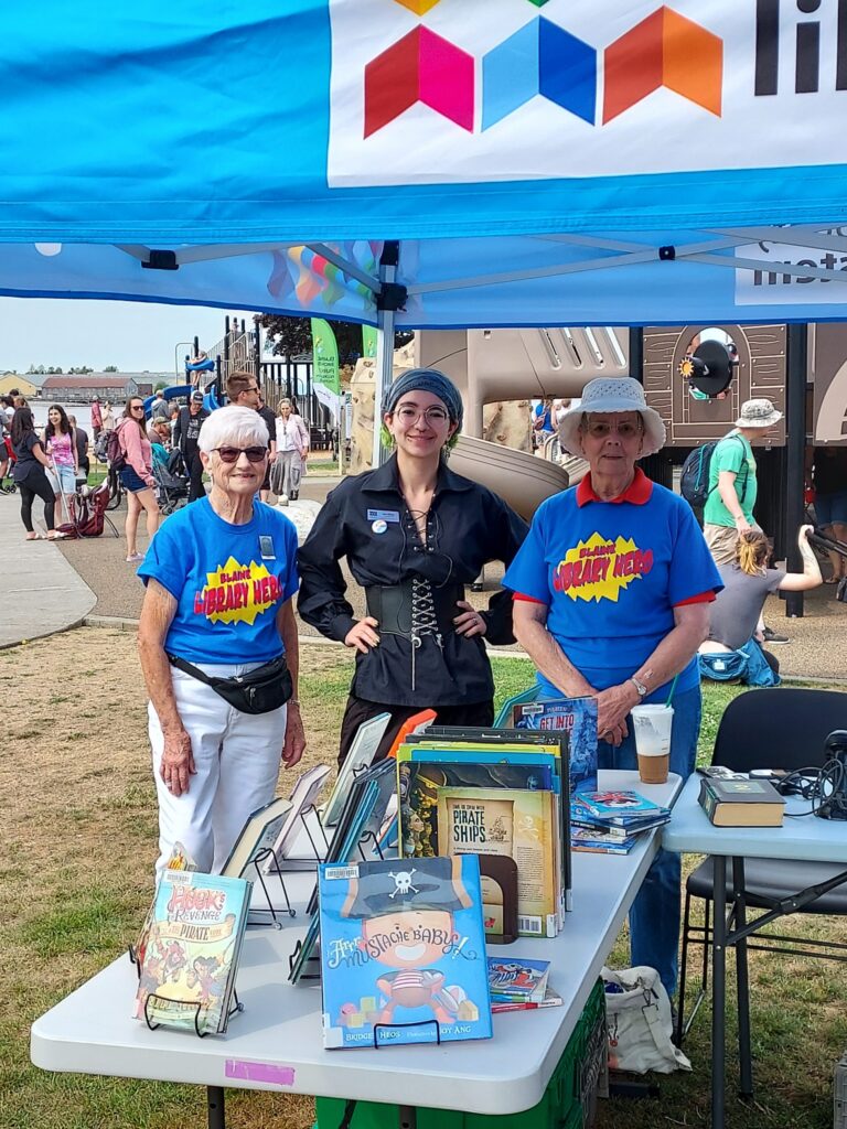 Friends of the Blaine Library with pirate-related books