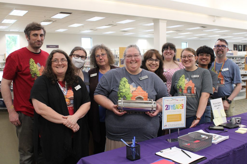 Lynden Library Staff holding time capsule on the library’s 20th anniversary.