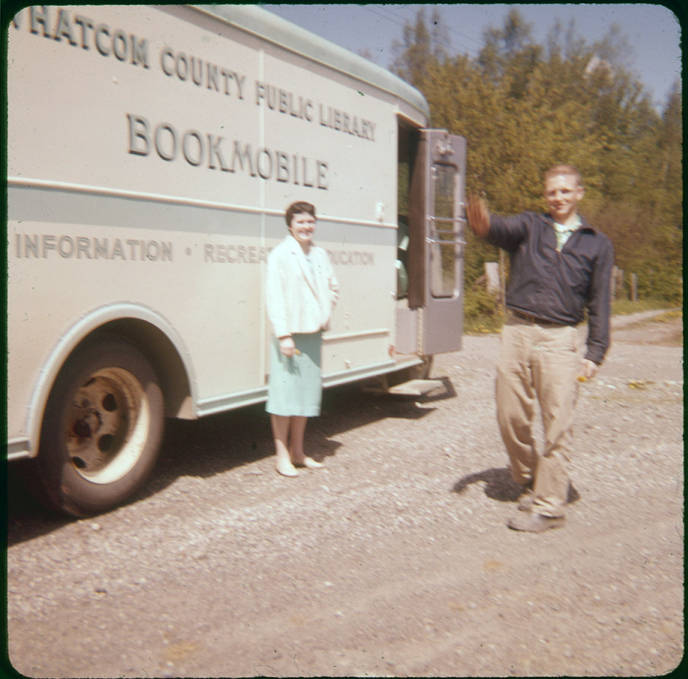 Old WCLS bookmobile with a man and a woman standing in front