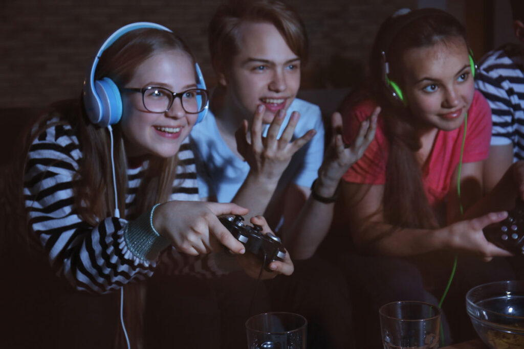 image of three teens playing video game